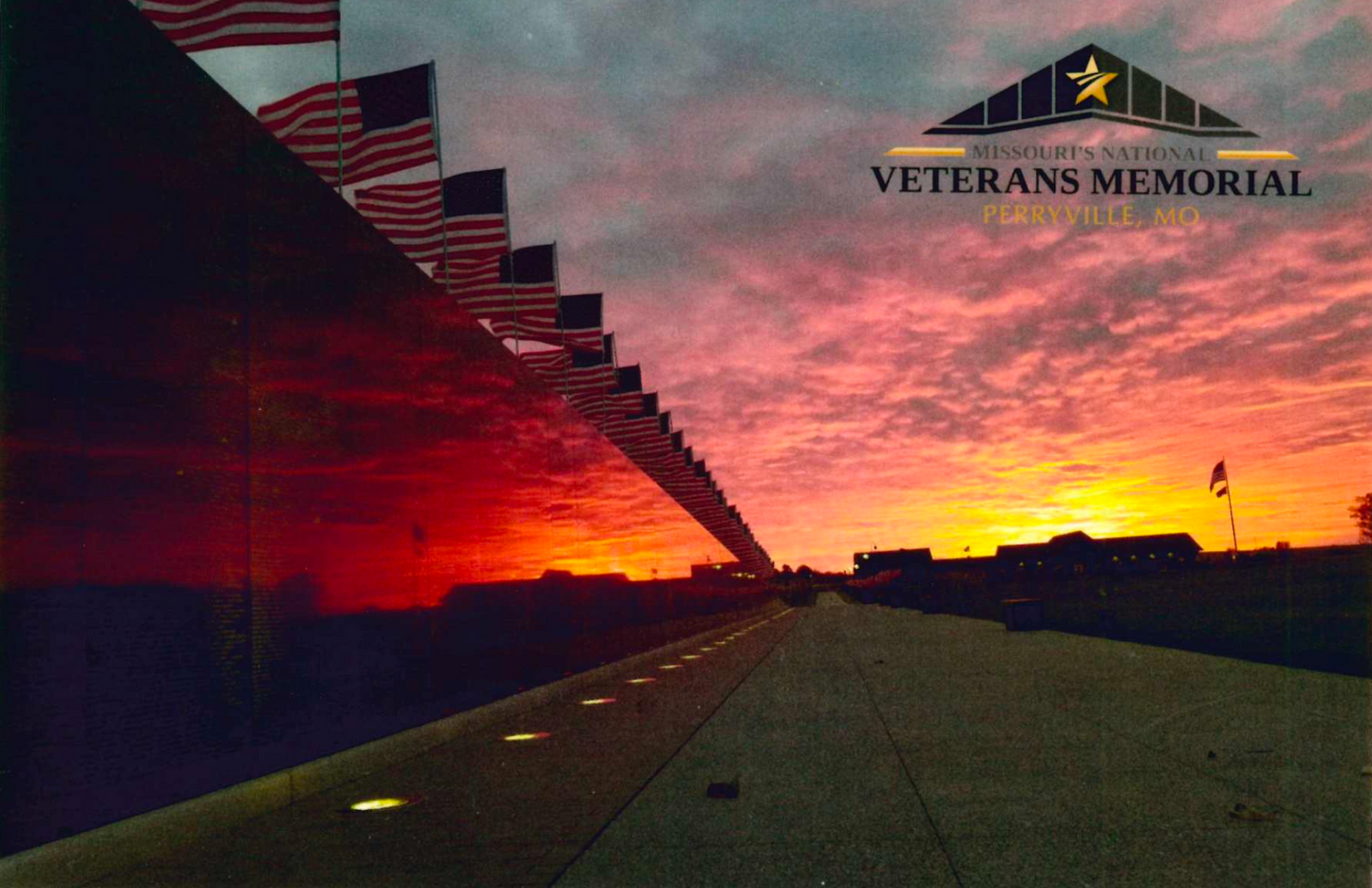 Post Card featuring United States Flags flying above American's Wall, the exact replica of the Vietnam Veterans Memorial wall in Washington DC, at Missouri's National Veterans Memorial with the sunrise in the background and reflecting off the wall. Post card also features Missouri's National Veterans Memorial logo