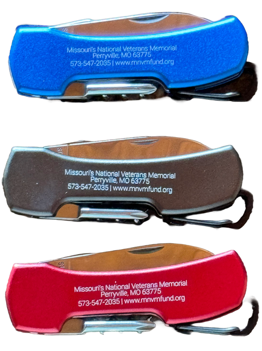 5-in-1 Knife with Carabiner Clip. Photo includes black, blue, and red knife. Each knife says Missouri's National Veterans Memorial, phone number, and website